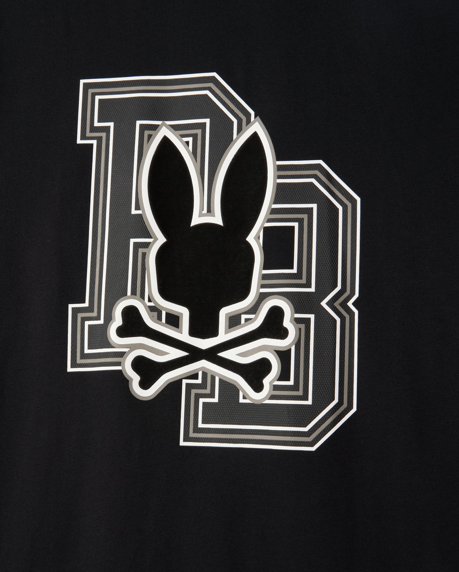 The MENS ZACK GRAPHIC TEE - B6U897D200 by Psycho Bunny features a black graphic tee with a bold letter 'B' outlined in white. Superimposed over the 'B' is a black silhouette of a rabbit head with long ears above two crossed bones, resembling a skull and crossbones motif. This unique design screams Psycho Bunny style.