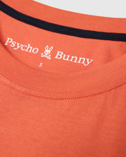 Close-up of the MENS ZACK GRAPHIC TEE by Psycho Bunny, crafted from soft Pima cotton in an orange hue and featuring a black-trimmed collar. The inner fabric showcases the Psycho Bunny brand name, logo, and a size label "S", encapsulating the essence of this standout graphic tee.