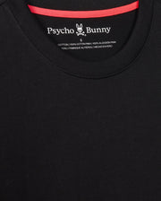 Close-up of a black MENS MONROE HEAVY WEIGHT RELAXED FIT TEE - B6U910D200 with a relaxed fit and red neckline. The logo of Psycho Bunny, featuring a stylized bunny skull and crossbones, is visible inside the collar area. Made of 100% Pima cotton.
