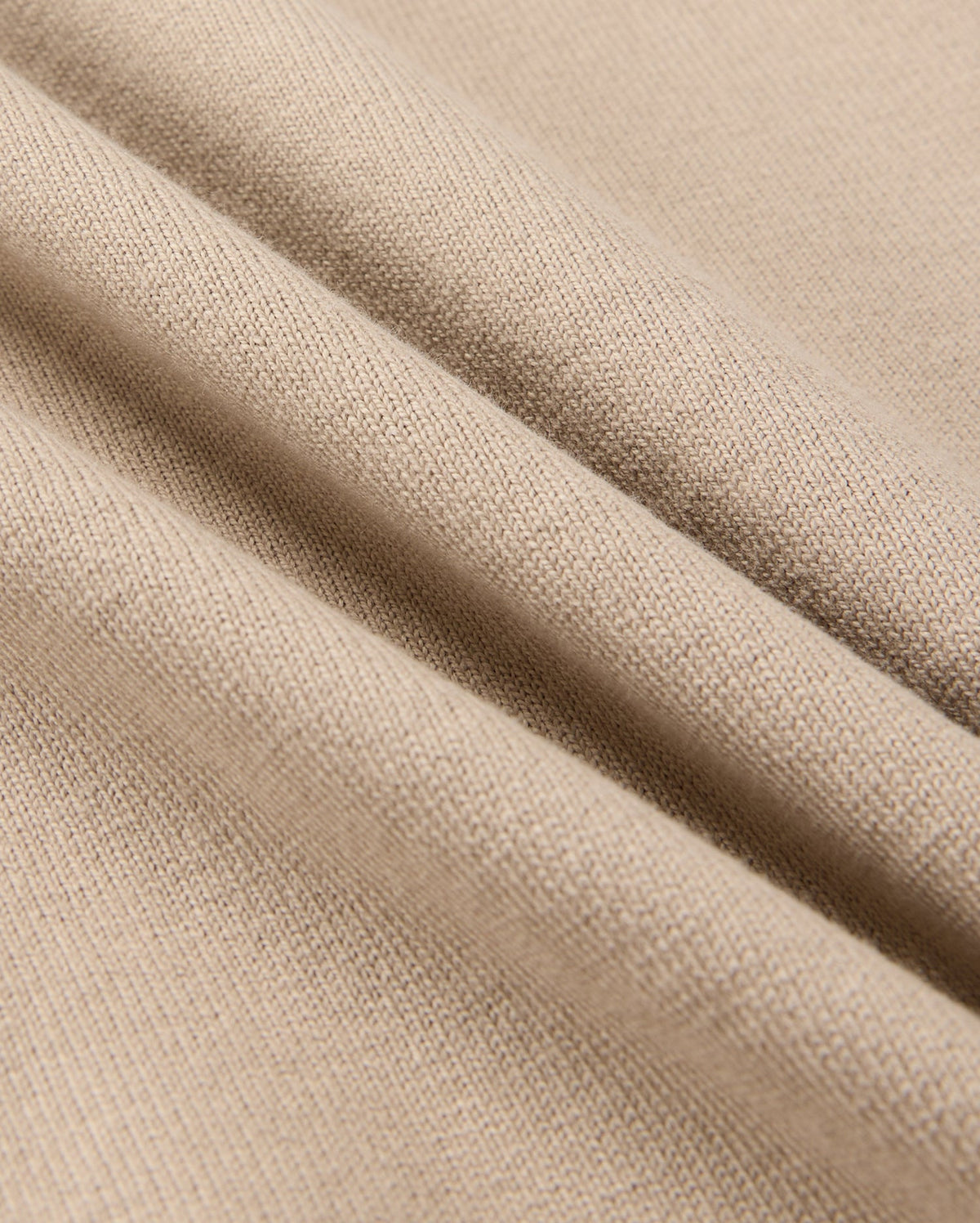 Close-up of Psycho Bunny's MENS MONROE HEAVY WEIGHT RELAXED FIT TEE in beige, crafted from Pima cotton, highlighting its detailed knit texture and smooth surface.