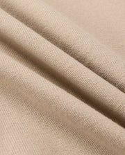 Close-up of Psycho Bunny's MENS MONROE HEAVY WEIGHT RELAXED FIT TEE in beige, crafted from Pima cotton, highlighting its detailed knit texture and smooth surface.