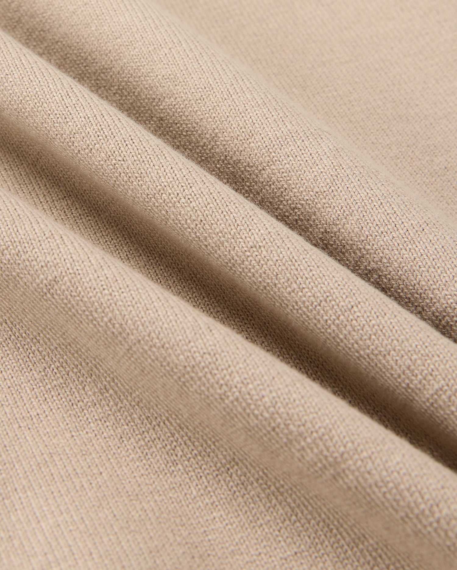 Close-up of Psycho Bunny's MENS MONROE HEAVY WEIGHT RELAXED FIT TEE in beige, crafted from Pima cotton, highlighting its detailed knit texture and smooth surface.