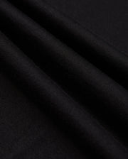 Close-up of the MENS JAMES PREMIUM CREW NECK TEE by Psycho Bunny, crafted from high-quality Pima cotton fabric with a smooth texture and several parallel folds. The surface of the tee is uniformly dark, creating subtle shadows along the meticulous embroidery that adds an elegant touch.