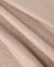 Close-up of the beige fabric with a smooth texture. The MENS JAMES PREMIUM CREW NECK TEE - B6U952D200 by Psycho Bunny is displayed in soft, loose folds, emphasizing its flexibility and softness.