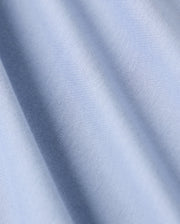 The Psycho Bunny MENS JAMES PREMIUM CREW NECK TEE (B6U952D200) features a close-up view of its premium quality light blue fabric, distinguished by fine diagonal lines. The smooth texture and subtle sheen highlight the softness typical of Pima cotton, with gentle waves and a consistent pattern throughout.