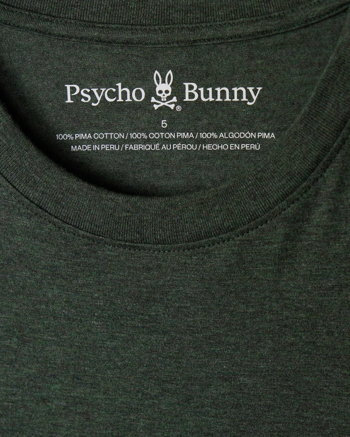 Close-up of the stylish MENS JAMES PREMIUM CREW NECK TEE - B6U952D200 in dark green, showcasing the "Psycho Bunny" label with a tonal outline bunny embroidered logo. Made from premium Pima cotton and crafted in Peru, this shirt is available in size 5.