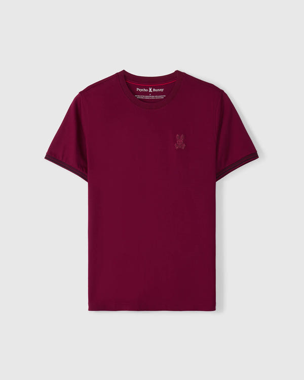 Introducing the Psycho Bunny Men's Malton Fashion Tee (B6U966D200), a chic T-shirt made from soft pima cotton. It features a small embroidered logo on the left chest, set against a light gray backdrop that enhances its vibrant burgundy color.