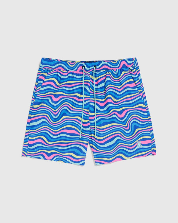 The MENS CLARKSON LIGHTWEIGHT  SWIM TRUNK - B6W120B2SW by Psycho Bunny is a pair of colorful quick-dry swim trunks with a wavy, psychedelic pattern in various shades of blue, pink, yellow, and white. Made from recycled polyester, these shorts feature an elastic waistband with a white drawstring and a small emblem on the left leg near the hem. The background is white.