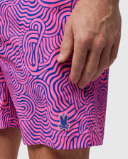 A person wearing VERONA PRINT SWIM TRUNK - B6W172B2SW by Psycho Bunny.