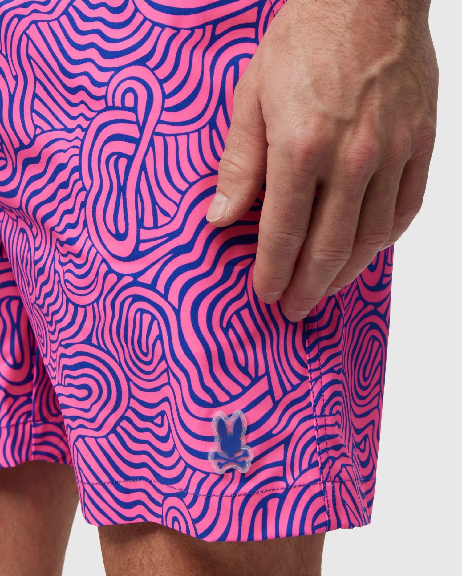A person wearing VERONA PRINT SWIM TRUNK - B6W172B2SW by Psycho Bunny.