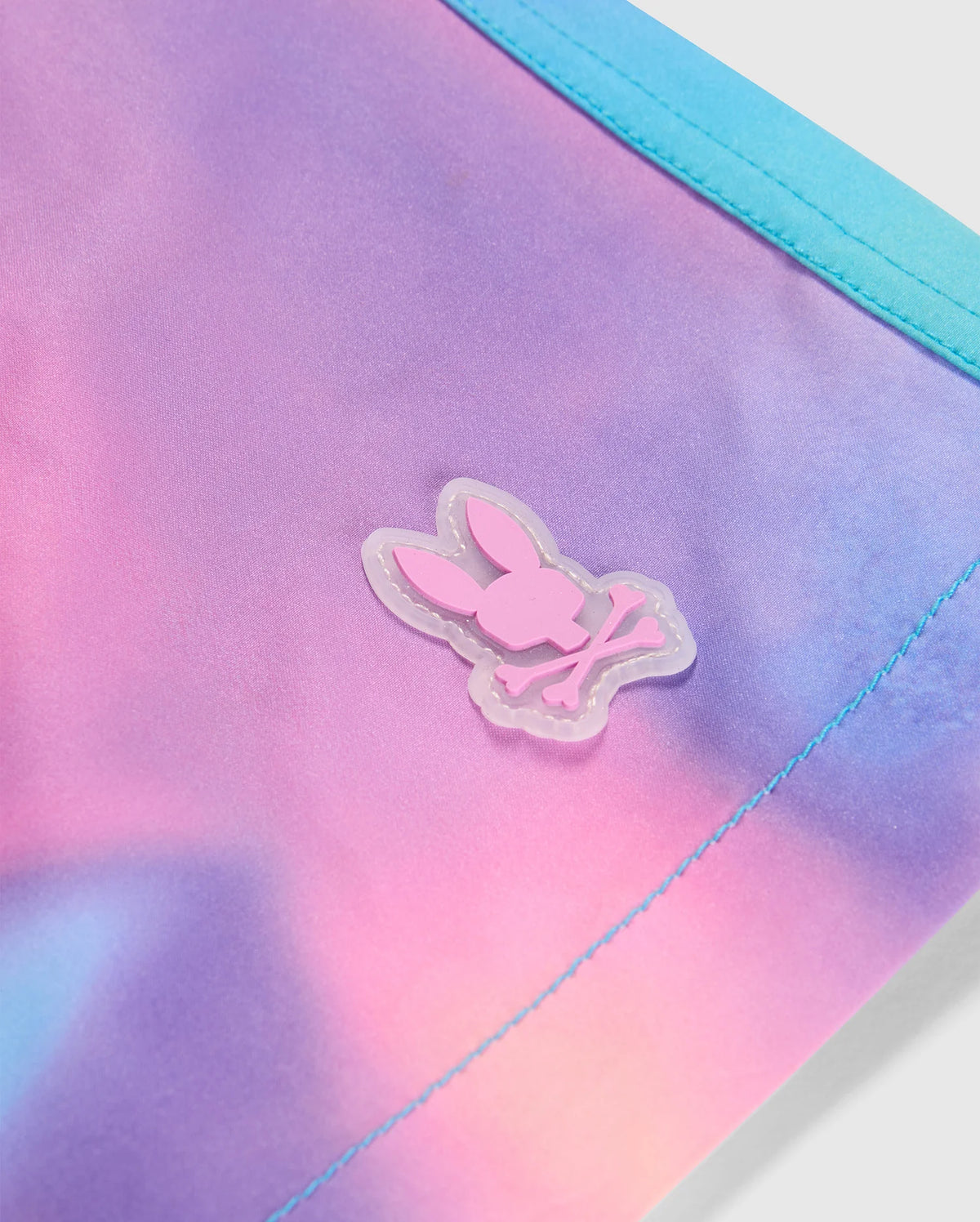 Logo detail of the men's tyler print swim trunk