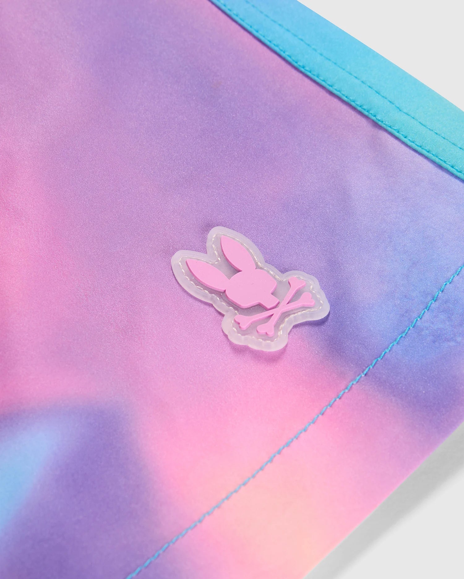Logo detail of the men's tyler print swim trunk