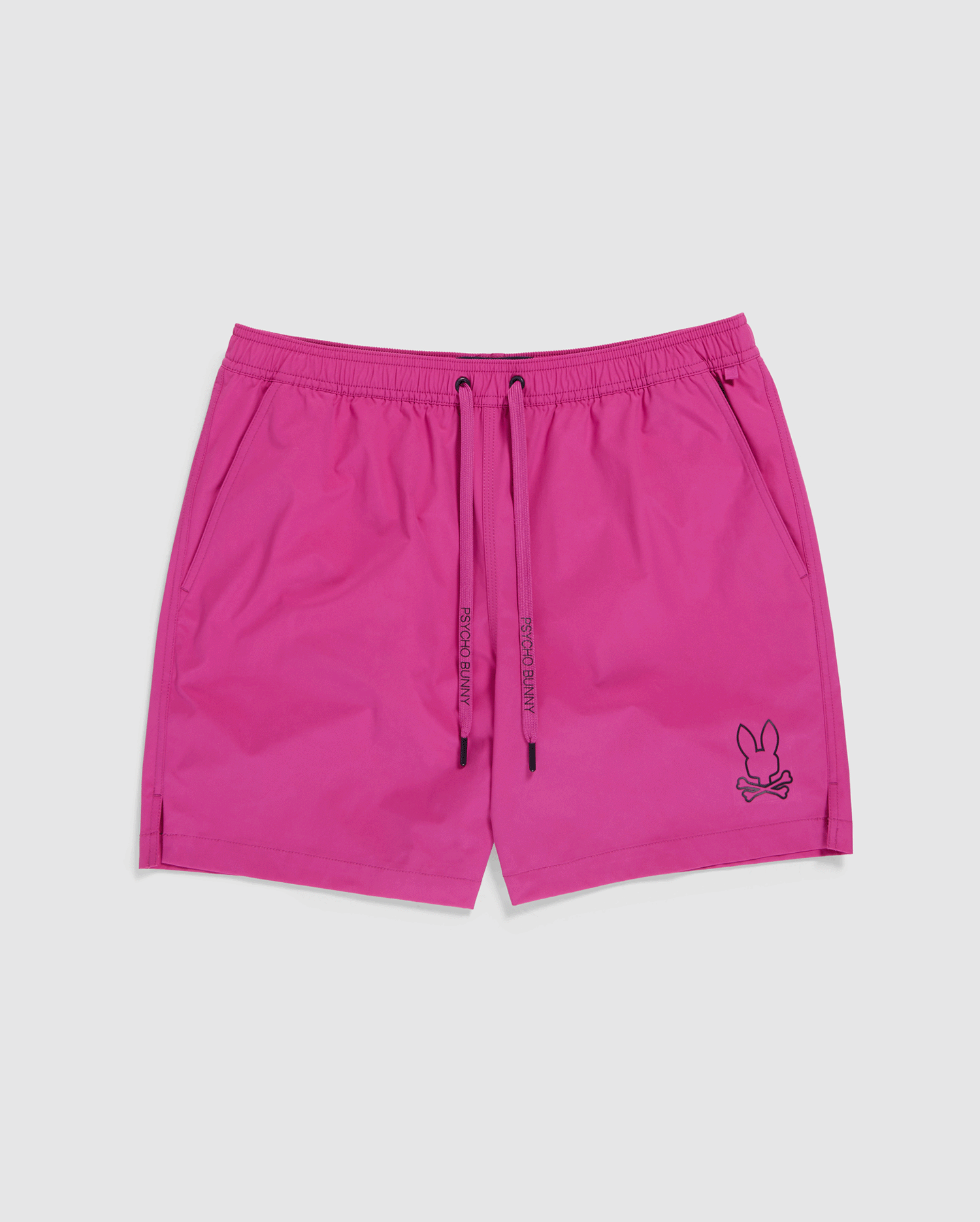 Bright pink, quick-drying swim shorts with an elastic waistband and drawstring tie. The MENS PARKER HYDROCHROMIC SWIM TRUNK - B6W646C200 by Psycho Bunny features side pockets and an embroidered bunny pattern with crossed bones near the bottom hem on the left leg.