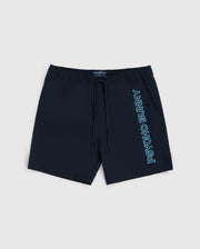 The MENS MELVIN SWIM TRUNK - B6W665C200 by Psycho Bunny are dark navy blue swim trunks featuring a drawstring stretch waistband. The quick-dry outer shell showcases the text "Psycho Bunny" written vertically in light blue on the left leg. These stylish shorts come with side pockets and are displayed on a plain white background.