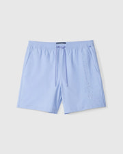 The MENS MELVIN SWIM TRUNK - B6W665C200 by Psycho Bunny features light blue swim trunks with an elastic waistband and drawstring, made from quick-dry textile. Embroidered vertically in white lettering on the right leg are the words "PSYCHO BUNNY." The shorts are laid flat against a white background.