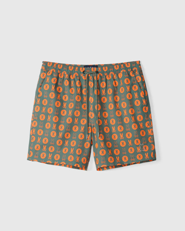 The Psycho Bunny MENS ARNOLD PRINT SWIM TRUNK - B6W820D200 features green swim shorts adorned with an orange geometric rabbit pattern. Made from quick-dry material, these shorts offer a comfortable stretch mesh lining and an elastic waistband with a drawstring. Set against a plain white background.