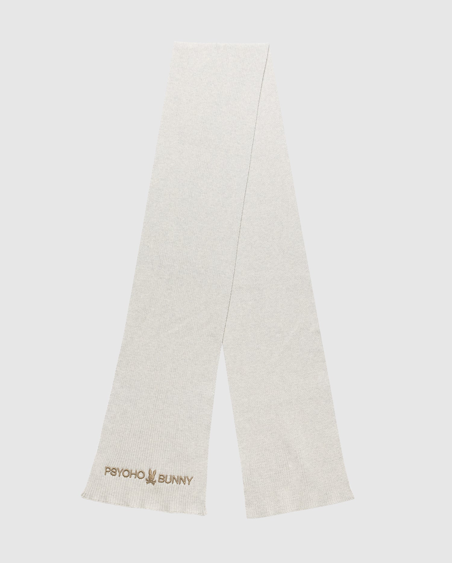 A light gray scarf from the Psycho Bunny MENS BEANIE AND SCARF BOX SET - B6X353E200 showcases the Psycho Bunny logo and text embroidered in the corner. This scarf highlights a simple, minimalist design and is photographed laid flat against a plain background.