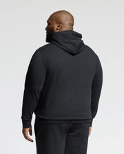 A man wearing a Psycho Bunny BIG AND TALL ALEXANDER HOODIE - B9H154E200 in black, along with matching pants, is shown from the back against a plain background.
