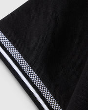 A close-up of folded black Pima cotton fabric with white and gray stripes along the edge resembles the textured surface of a Psycho Bunny Big and Tall Malton Pique Polo Shirt B9K950D200, highlighting its smooth folds and contrasting stripe.