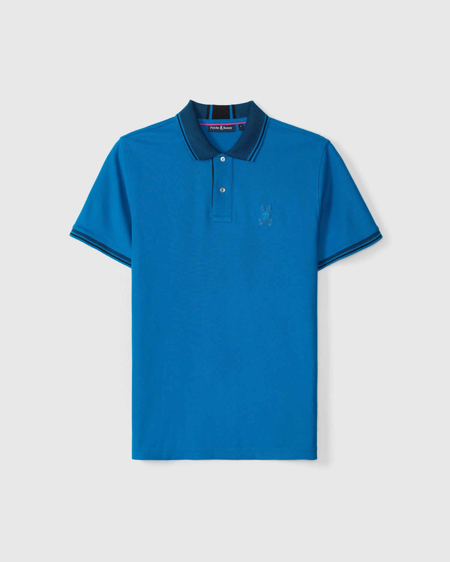 The BIG AND TALL MALTON PIQUE POLO SHIRT - B9K950D200 by Psycho Bunny features blue pima cotton with a dark blue collar, thin stripe trim on the sleeves, a three-button placket, and an embroidered rabbit logo on the chest, set against a plain white background.