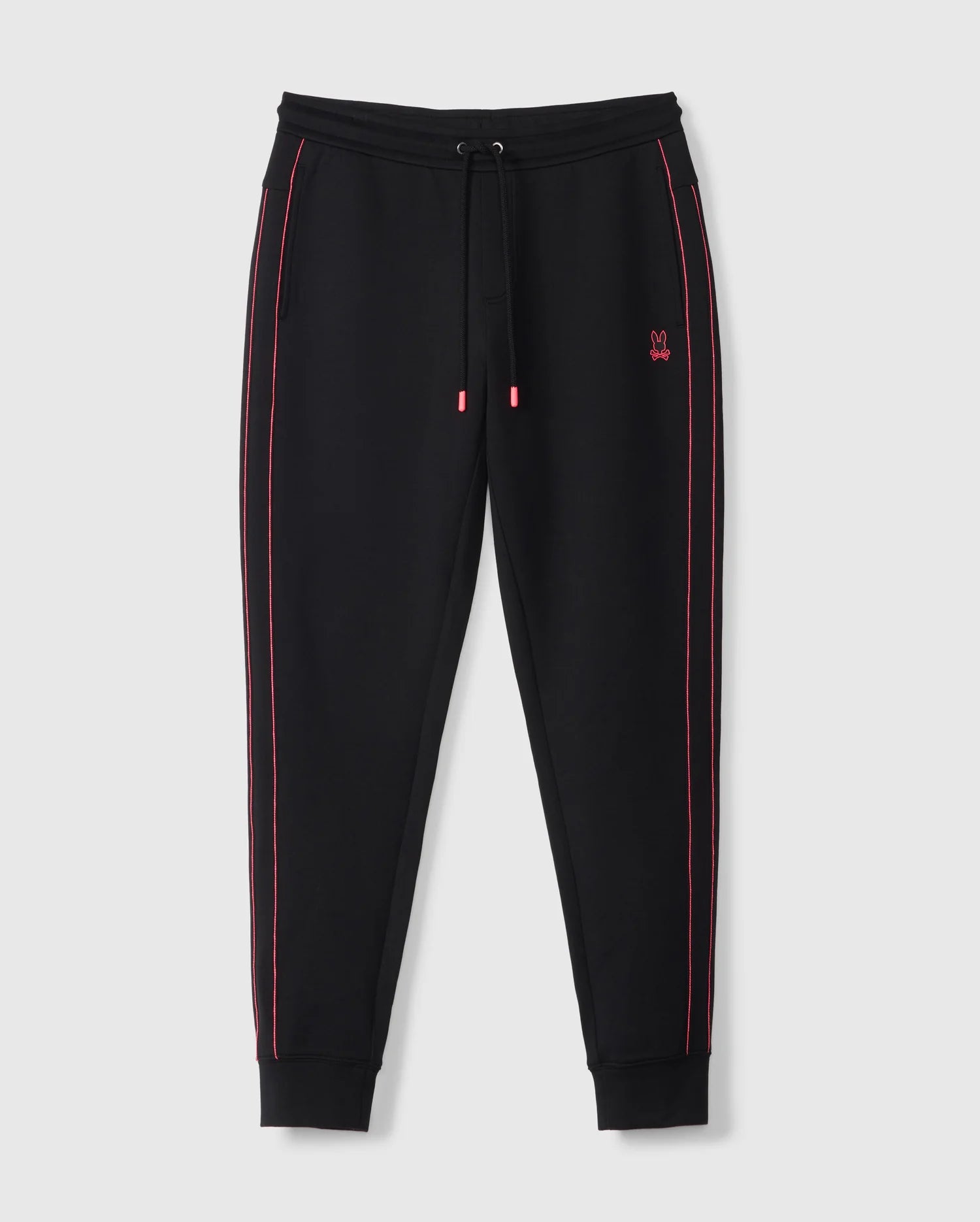 The Psycho Bunny BIG AND TALL TRAVIS TRACK PANT (B9P143D200) features black fabric with pink piping, a small pink embroidered logo on the left leg, an adjustable elastic drawstring waist, and fitted ankle cuffs for stylish comfort.