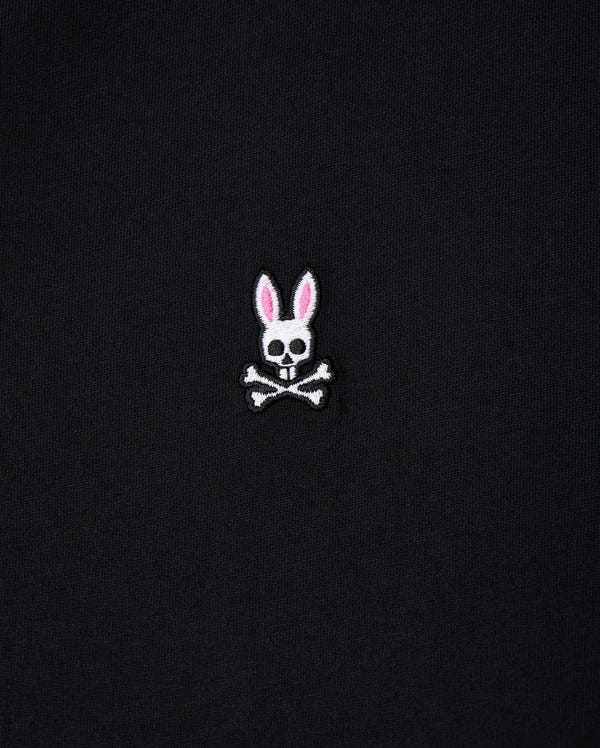 The Psycho Bunny Men's Big and Tall Classic Crew Neck Tee (B9U014CRPC) showcases a white skull with rabbit ears, pink interior, and crossbones. Made from 100% Pima cotton, this elegant design pops on its black fabric background.