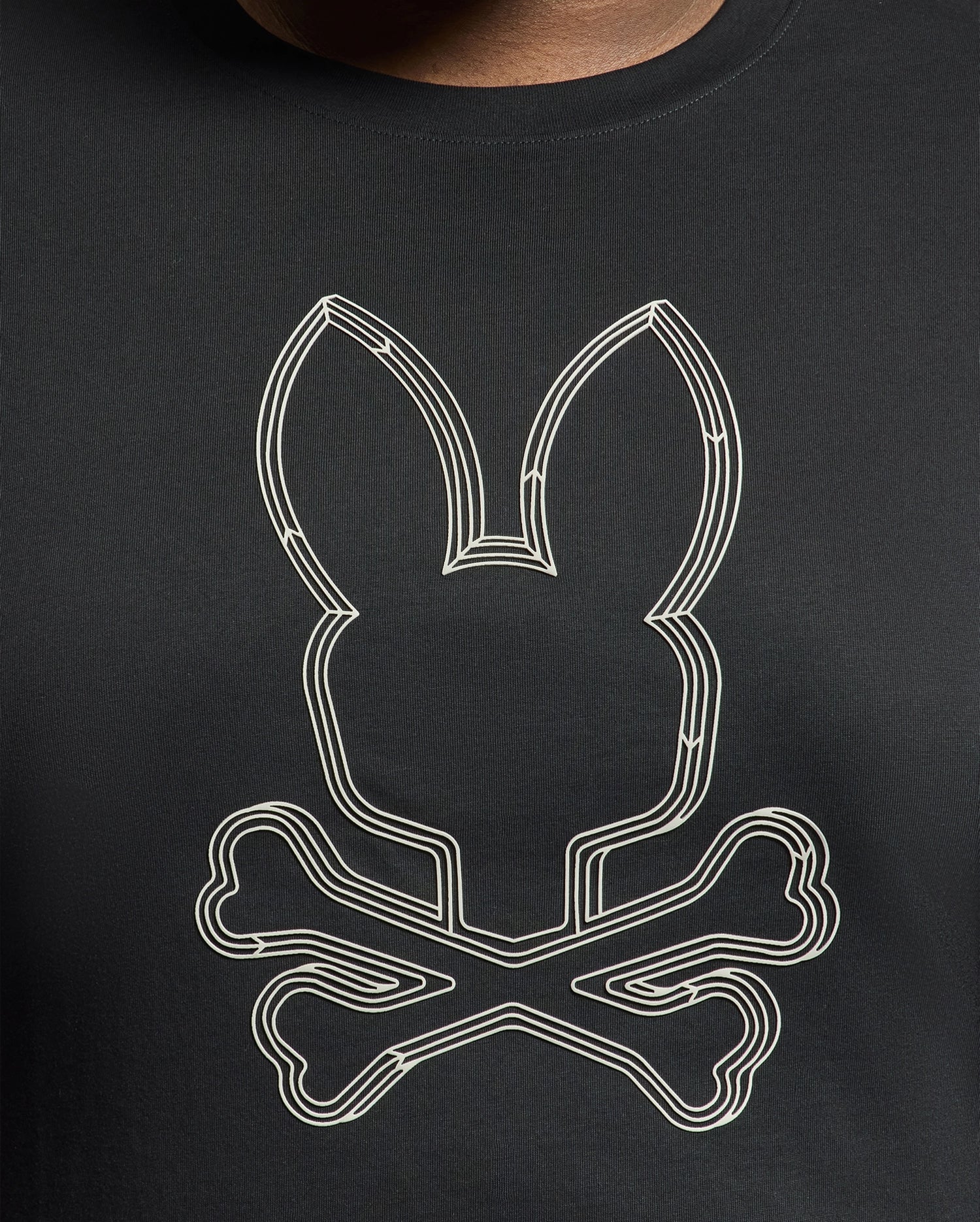 The Psycho Bunny Men's Big and Tall Monarc Front Bunny Graphic Tee, model B9U211E200, is a black premium Pima cotton tee featuring a white rabbit head outline with crossed bones.