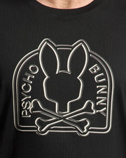 The Men's Big and Tall Melbourne Graphic Tee B9U410F200 by Psycho Bunny features a black Peruvian Pima cotton shirt with a stylized bunny silhouette above crossed bones, encircled by "Psycho Bunny," offering stylish, eco-friendly comfort.