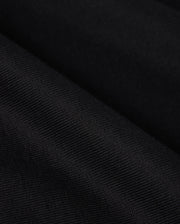 Close-up of a black heavyweight Pima cotton fabric with diagonal texture, subtle pattern, and smooth appearance. The image evokes elegance and simplicity, reminiscent of the relaxed-fit BIG AND TALL DUKE OVERSIZED TEE by Psycho Bunny.