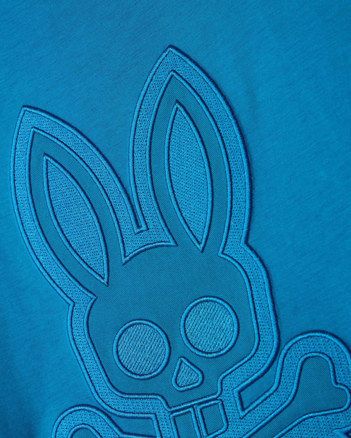 The BIG AND TALL MALTON GRAPHIC TEE - B9U795D200 by Psycho Bunny features a detailed blue embroidered design on premium Pima cotton, showcasing a rabbit with large ears and round eyes and a skull and crossbones motif against a matching blue background, highlighting exquisite Peruvian craftsmanship.