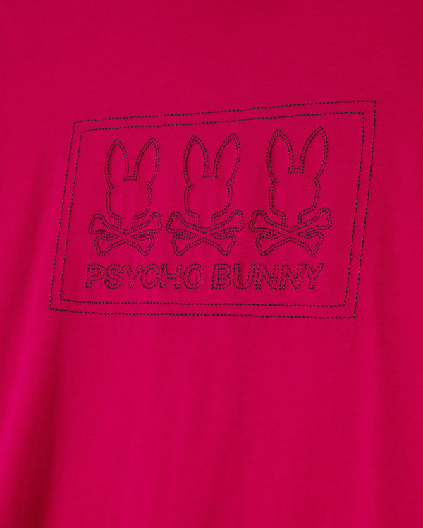 The Psycho Bunny BIG AND TALL TACOMA GRAPHIC TEE - B9U909D200 is a soft Pima cotton red tee featuring three embroidered bunny skull logos with crossed bones and the "Psycho Bunny" name elegantly framed below the design.