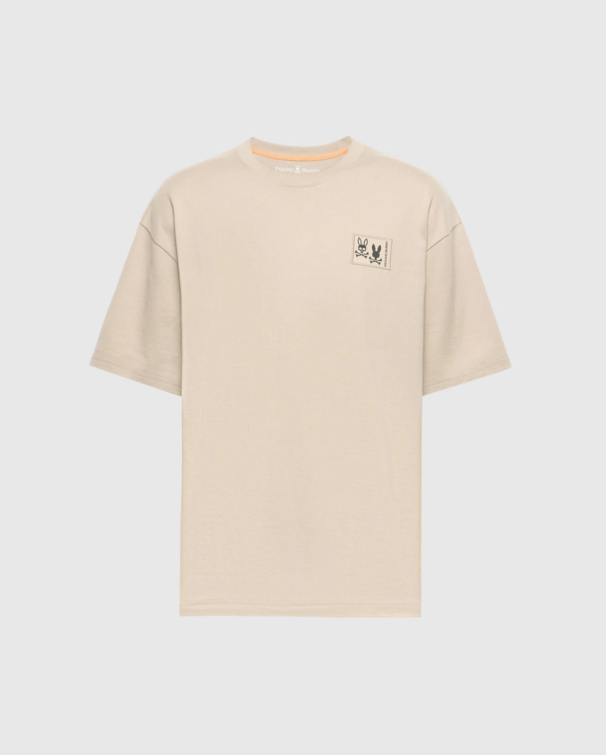 The Psycho Bunny Men's Big and Tall Monroe Oversized Tee - B9U910D200 is a light beige, soft pima cotton T-shirt with a relaxed fit crew neckline, short sleeves, and a minimalistic rectangle graphic with an illustration and text on the left chest against a white background.