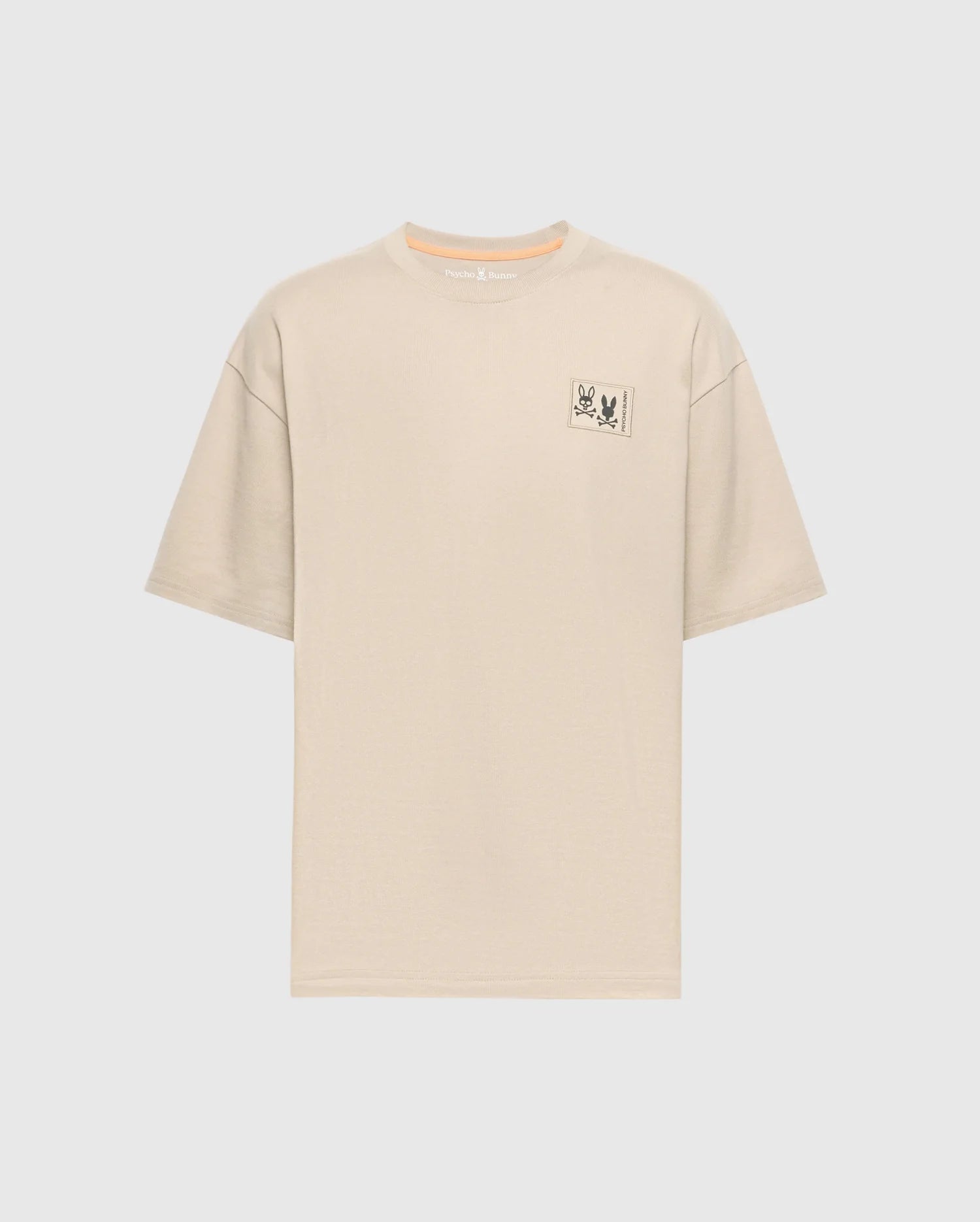 The Psycho Bunny Men's Big and Tall Monroe Oversized Tee - B9U910D200 is a light beige, soft pima cotton T-shirt with a relaxed fit crew neckline, short sleeves, and a minimalistic rectangle graphic with an illustration and text on the left chest against a white background.