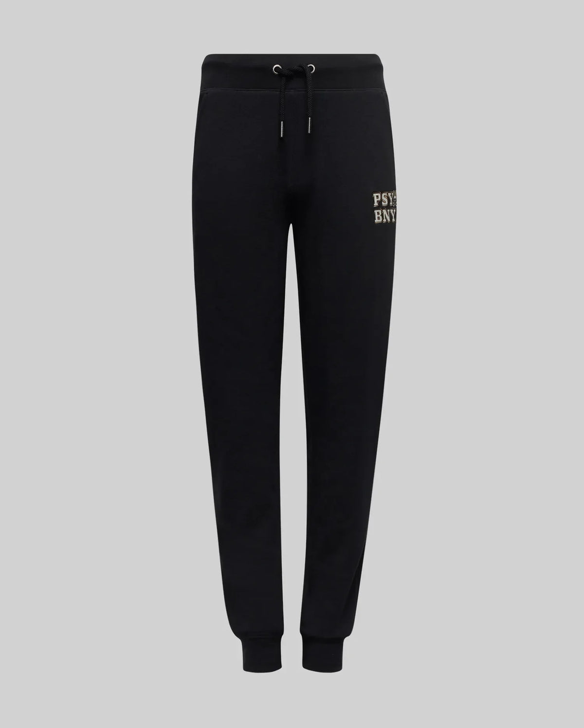 The Psycho Bunny KIDS WADE SWEATPANT (KB0800002) features black jogger pants with an elastic waistband, drawstrings, cuffed ankles, and a small beige embroidered wordmark on the upper left thigh, made from a premium cotton blend.