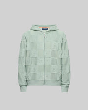 The Psycho Bunny KIDS KELVIN FULL ZIP TOWEL TERRY HOODIE - KT0500004 is a light green cotton blend zip-up with a Jacquard terry checkered pattern, shown on a plain grey background.