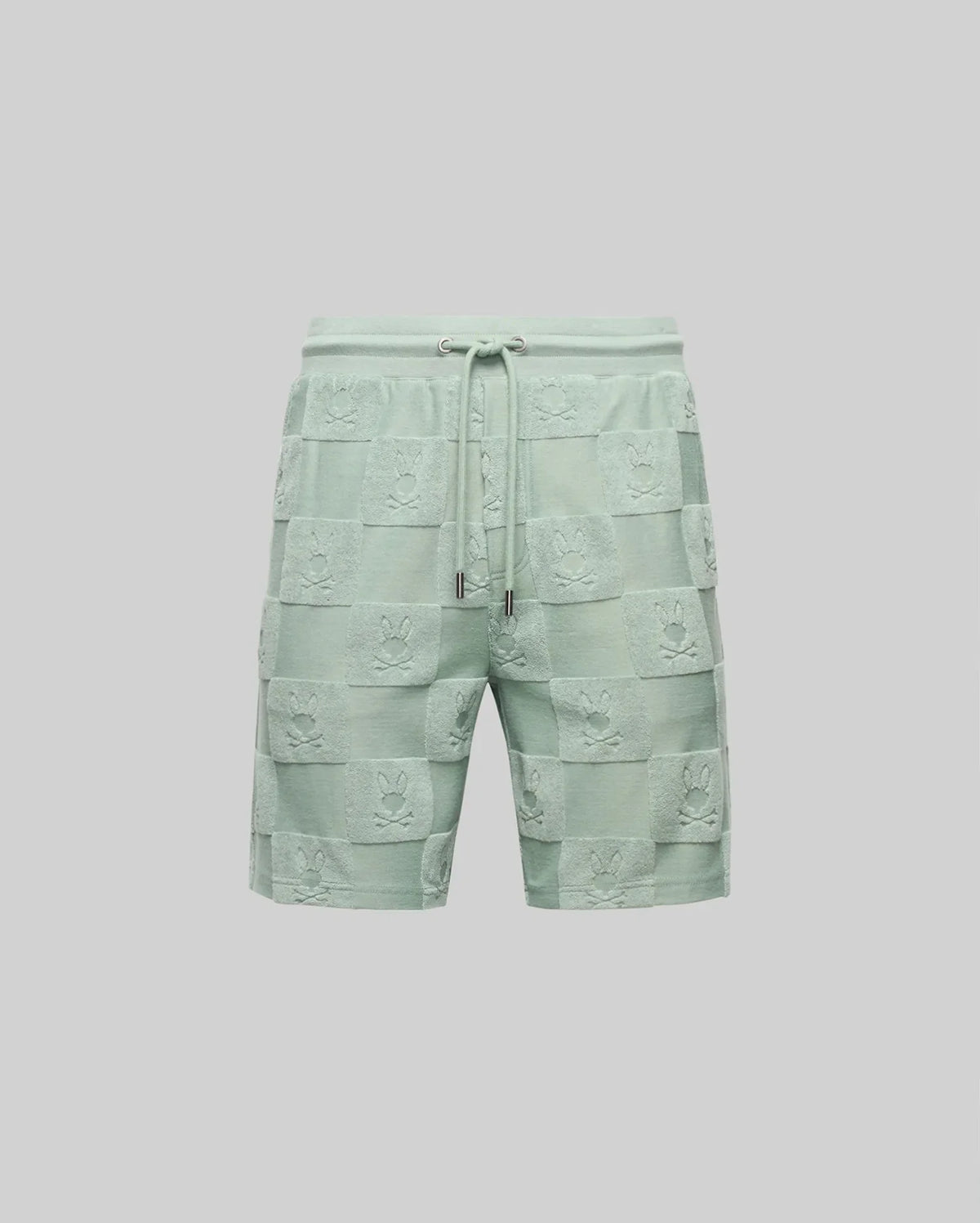 The Psycho Bunny MENS KELVIN TOWEL TERRY SWEATSHORT (MB0900006) features light green cotton-blend fabric with a jacquard terry checkered texture and embossed designs on each square, shown against a plain gray background.
