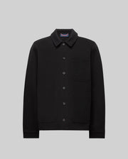 The Psycho Bunny MENS AVEN KNIT SHACKET (MO1100035) is a black button-up knit shacket with a collar, three front pockets, and an embroidered cartoon bunny face on the left chest pocket, shown on a plain gray background.