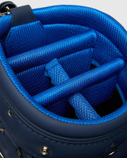 The OUTLINE BUNNY GOLF TOUR BAG - PBMG4FC1 by Psycho Bunny features a close-up of its interior with textured fabric, padded dividers for club protection and organization, and a detachable strap for convenience.