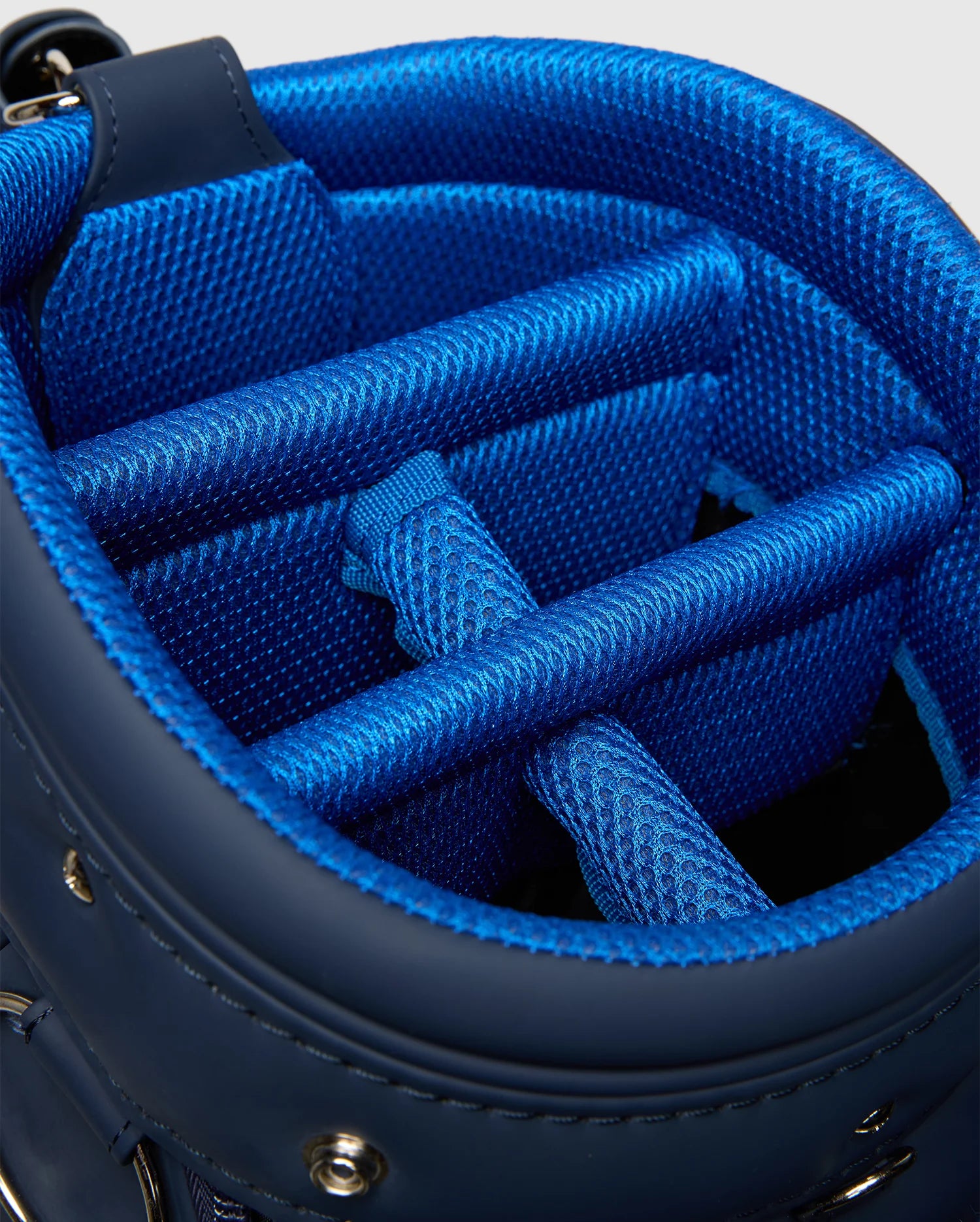 The OUTLINE BUNNY GOLF TOUR BAG - PBMG4FC1 by Psycho Bunny features a close-up of its interior with textured fabric, padded dividers for club protection and organization, and a detachable strap for convenience.