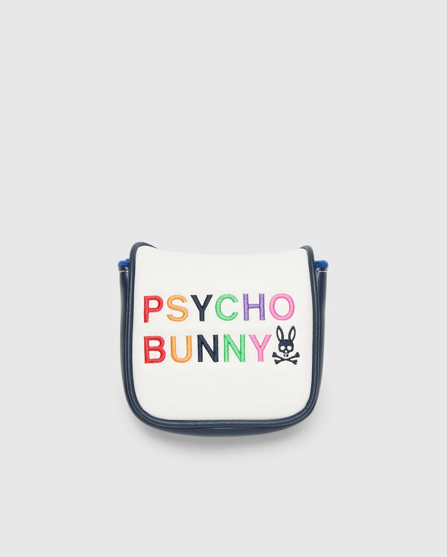 A small white golf putter cover with a navy border, made in China, showcases "Psycho Bunny" in colorful block letters. A bunny logo with crossbones completes the playful design.