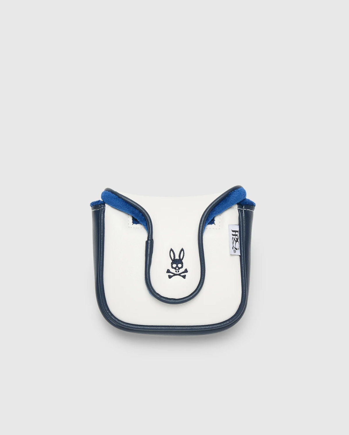 A small, white and blue crossbody bag with black trim, made from durable polyurethane. It showcases a Psycho Bunny logo with crossbones on the front and a side branded tag. Manufactured in China, it's displayed against a plain light background.