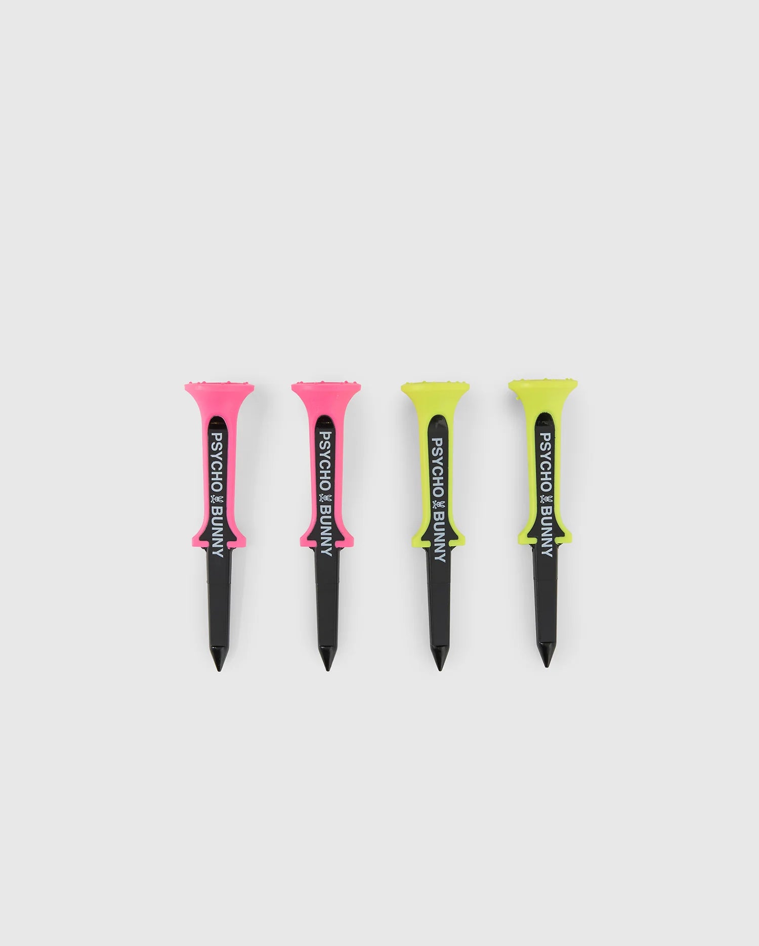 Four golf tees are lined up on a white background—two pink, two yellow, all with black bases and "Psycho Bunny" in bold black text—the ideal accessory for the best-dressed on the course. Perfectly matches the MULTICOLOR MIXTE GOLF TEES - PBMG4FT1 collection by Psycho Bunny.