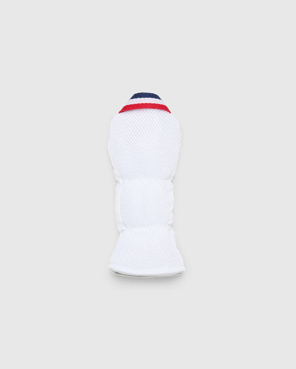 The MULTI BUNNY HYBRID HEAD COVER - PBMG4SH3 by Psycho Bunny is a white protective sports pad with red and blue accents. Made from durable ripstop fabric, it offers flexibility and cushioning for limb protection. This stylish piece is presented on a light gray background.
