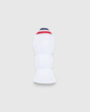The MULTI BUNNY HYBRID HEAD COVER - PBMG4SH3 by Psycho Bunny is a white protective sports pad with red and blue accents. Made from durable ripstop fabric, it offers flexibility and cushioning for limb protection. This stylish piece is presented on a light gray background.