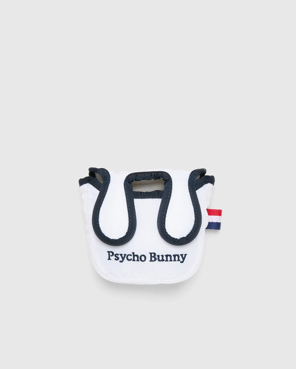 The MULTI BUNNY MALLET PUTTER COVER - PBMG4SH6 by Psycho Bunny is a small white pouch with black trim, featuring a red and blue striped tab, perfect as a golf accessory. The front is embroidered with "Psycho Bunny" in black. It has a rounded top flap and minimalist design ideal for mallet putters.