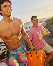 front view on-model action shot of male wearing tyler swim trunk at the beach
